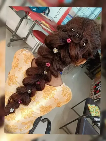This overhead shot gives a clear view of the intricate pull-through braid. Students are taught to create hairstyles that are not only beautiful but also structurally sound and long-lasting.