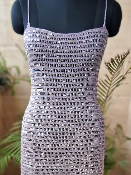 This handmade crochet cocktail dress, intricately woven with shimmering sequins, represents our vision of blending timeless craft with contemporary glamour. It's a statement piece designed to make you shine at any special occasion.