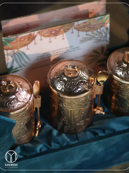 A close-up of the intricate embossing on our rose-gold mukhwaas jars. Each jar comes with a tiny matching spoon, a detail that reflects our commitment to thoughtful design.
