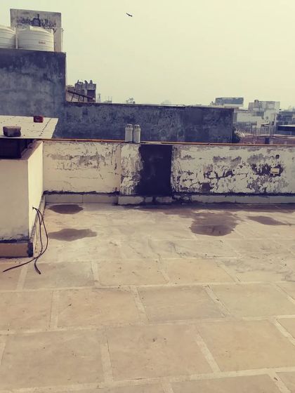 Before: A typical unused terrace with peeling walls and water damage. We see the potential for a beautiful outdoor living area.