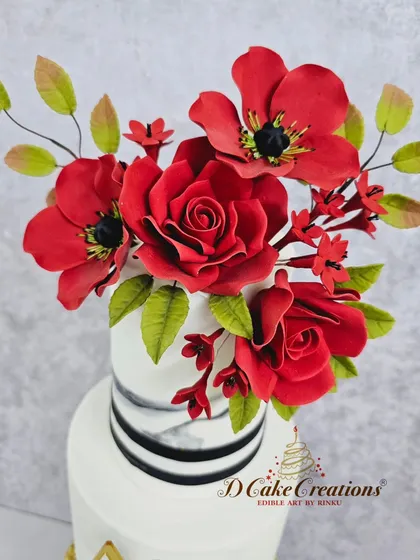 A close-up of the top tiers, focusing on the delicate marble effect and the expertly crafted sugar flower bouquet that crowns this unique wedding cake.