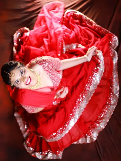 An artistic top-down shot that captures the beautiful circular flare of the lehenga. This creative angle makes for a very memorable image.
