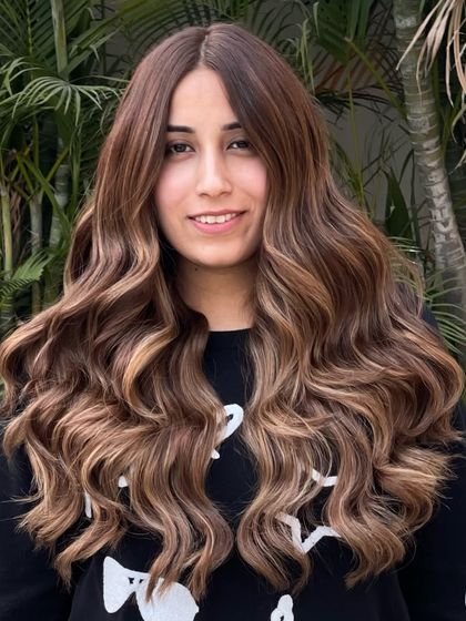 A stunning brunette balayage without bleach, styled into beautiful, flowing waves. This shows you can have it all: color, style, and health.