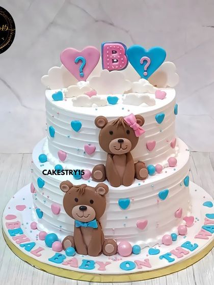 An adorable two-tier teddy bear cake for a gender reveal party. This 2kg black forest cake features "boy" and "girl" teddies with pink and blue hearts, asking the big question.