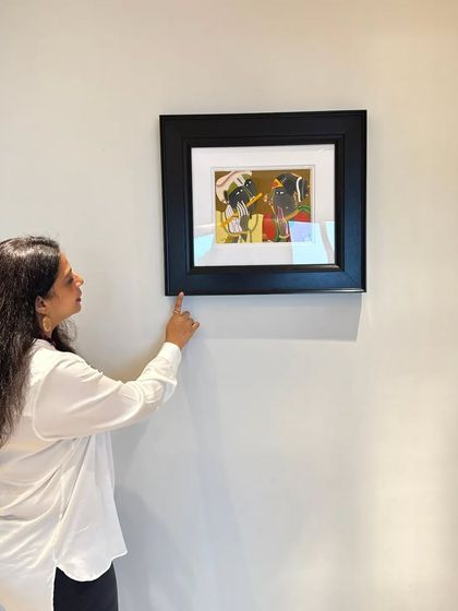 I love finding art that is both modern and rooted in tradition. This small, framed painting adds a touch of character and color to a simple white wall, proving that even small art can have a big impact.