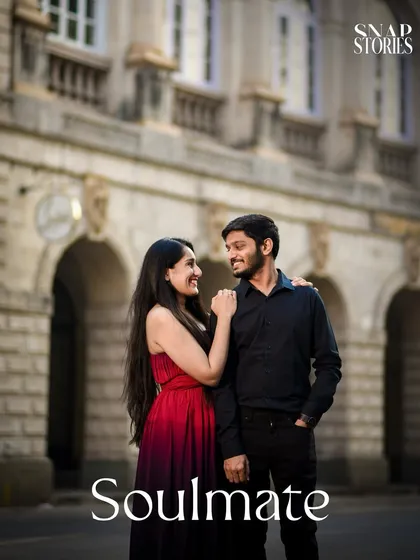 Capturing a candid, smiling moment against the backdrop of a classic Mumbai building, this photo embodies the charm of a city-based pre-wedding shoot.