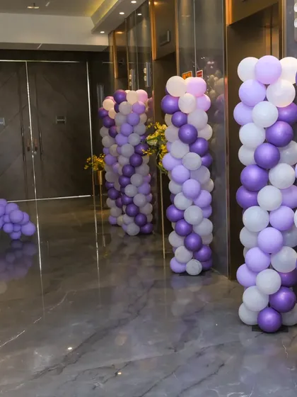 The entrance hallway was lined with purple and white balloon pillars, creating an immersive experience for guests as they arrived.