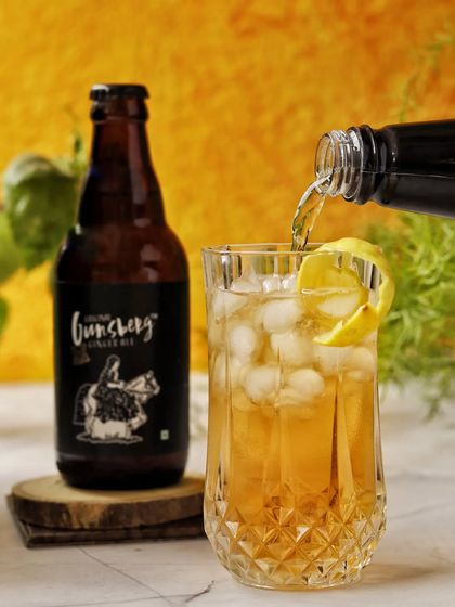 Weekend vibes are captured with this refreshing pour of ginger ale into a glass of ice. The warm, yellow background and natural light make this drink look incredibly crisp and inviting.