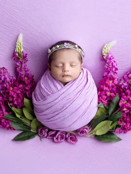 A stunning portrait with a lavender wrap and a backdrop of purple flowers, creating a vibrant and artistic image.