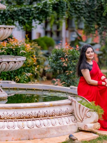 A couple in traditional attire by the fountain, showing how this classic set works beautifully for both modern and ethnic photoshoots.