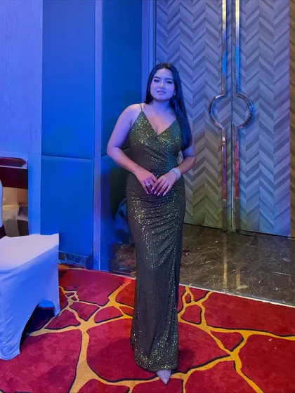 A full-length view of the olive green gown. The simple, elegant silhouette is flattering and easy to move in, which is very important for a host.