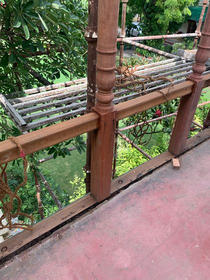 A detail of the restored balcony railing, showing the careful joinery and the beautiful grain of the wood.