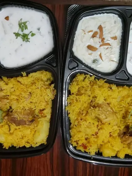 Indulge in our aromatic chicken biryani, prepared by expert home chefs. This complete meal comes with fragrant, long-grain rice and tender chicken, perfectly paired with cooling raita and a delicious sweet side.