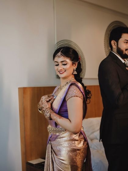 A candid getting-ready shot of bride Ishwarya and her groom. My draping is designed to look beautiful from all angles, even in unposed moments.