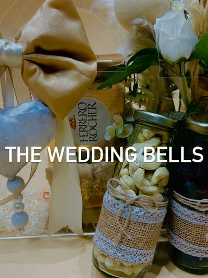 A close-up of the contents of our acrylic Rakhi hamper, featuring Ferrero Rocher chocolates and jars of premium cashews and dried fruits.