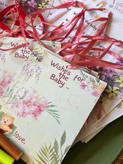 Custom "Wishes for the Baby" cards with a floral and teddy bear design, ready for guests to share their love.