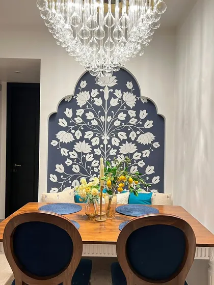 A client's dining room featuring my classic dining table and chairs. The chairs are upholstered in a rich blue velvet.