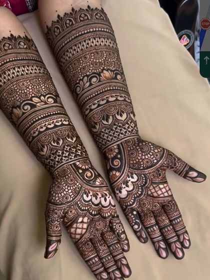 This design showcases incredible intricacy, with multiple bands of different patterns creating a rich and detailed look all the way up the arm.