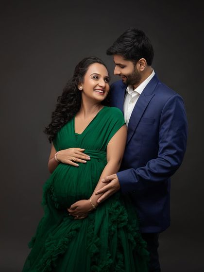 The look they share is full of love and excitement. His classic blue suit perfectly complements her stunning green gown.