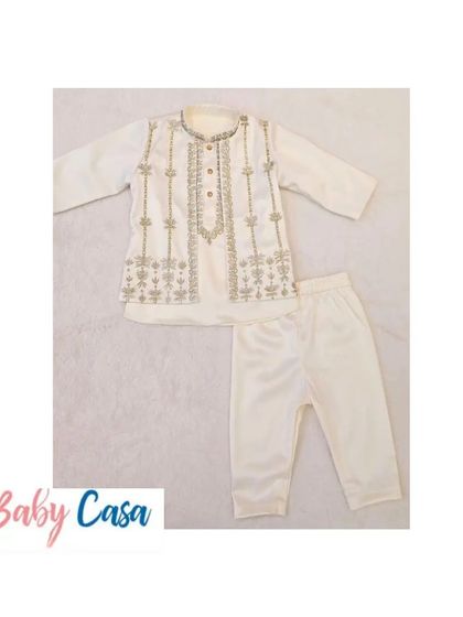 A classic off-white kurta pajama set with delicate silver embroidery. This timeless piece is perfect for any festive occasion, from Diwali puja to a family wedding.