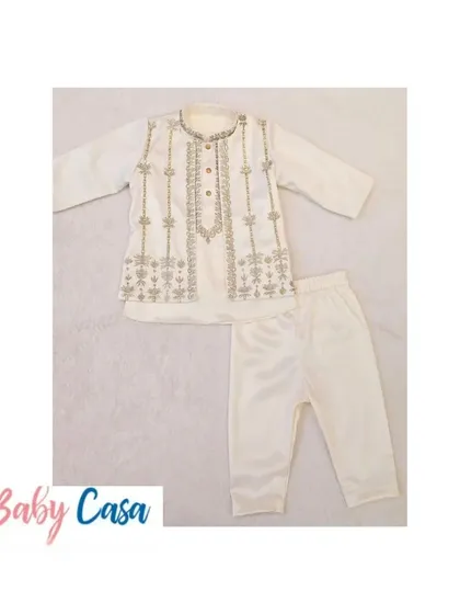 A classic off-white kurta pajama set with delicate silver embroidery. This timeless piece is perfect for any festive occasion, from Diwali puja to a family wedding.