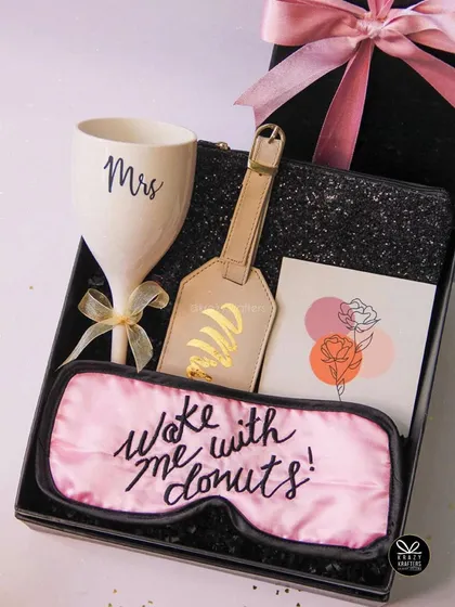 Celebrating the bride-to-be should be fun and personal. This hamper is all about pampering her with a custom 'Mrs' wine glass, a cheeky sleep mask, and a personalized luggage tag for her honeymoon adventures.