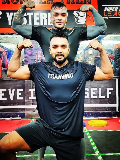 Posing with a fellow fighter. We are both dedicated to the art of training and building power.