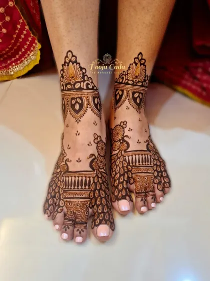 A stunning feet mehendi design where the two feet come together to form a complete picture of a majestic peacock.