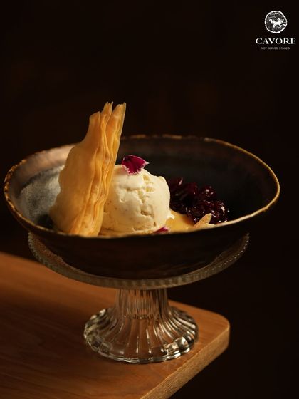 The final act of the meal. A scoop of rich, house made ice cream is paired with a sweet fruit compote and a crisp, flaky tuile for a dessert that is both comforting and elegant.