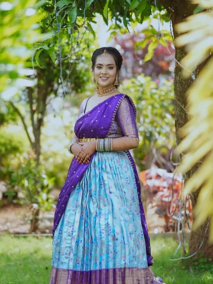 Our beautiful client looks absolutely radiant in this custom-fit South Indian half saree, or Langa Voni. We love combining traditional fabrics with modern designs to create the perfect outfit for your special cultural events.