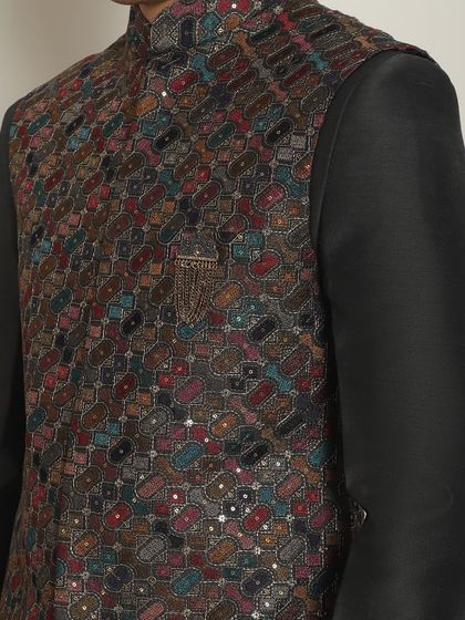 A close-up of a charcoal-colored bundi with multi-color embroidery. This piece can make you stand out at any Sangeet or Mehendi night.