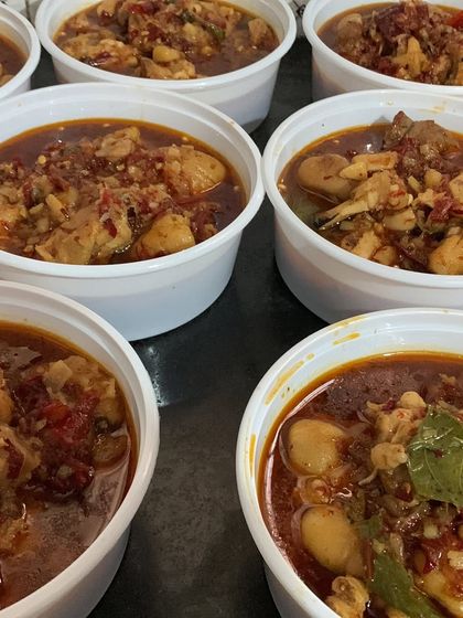A close-up of the chicken curry in delivery containers.