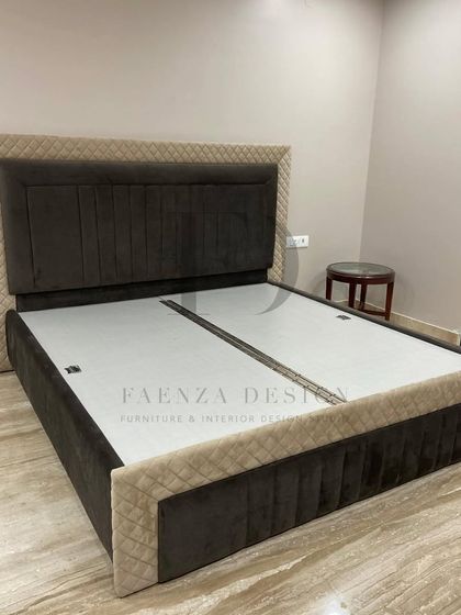 A custom bed with a two-tone, quilted design. The combination of dark and light fabrics on the headboard and frame adds visual interest and a bespoke touch to this bedroom set.
