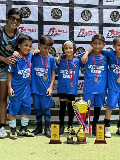Our U-7 team celebrating their well-deserved tournament win with Coach Shruti. This is just the beginning for these young champions.