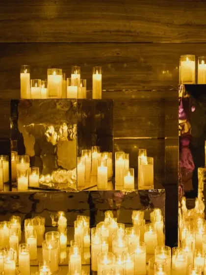 A sea of candles set on mirrored pedestals creates an infinitely reflective, magical glow. I use lighting as a primary tool to sculpt spaces and create a warm, intimate, and dramatic ambiance.