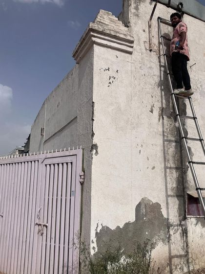 My technician assessing the wall before drilling. We check the structure to ensure a secure mount that can support the camera for years to come.