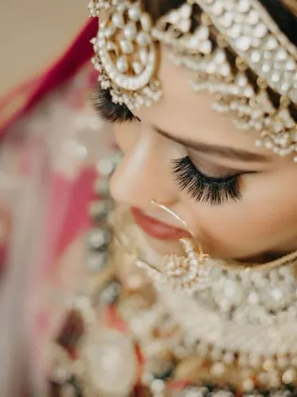 A detailed close-up of the eye makeup. You can see the precision of the eyeliner, the blend of eyeshadows, and the dramatic effect of the false lashes. This is where artistry truly shines in bridal makeup.