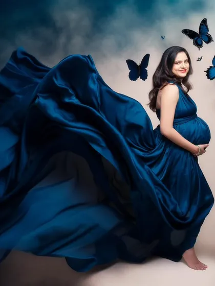 A swirl of blue silk, a flutter of butterflies, and the quiet anticipation of a new life. This frame is a story wrapped in elegance and grace, a fantasy brought to life.