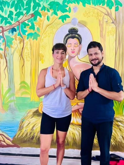 Posing with a student in front of our studio's Buddha mural. This artwork serves as a constant reminder of the peace and mindfulness we cultivate in our practice.