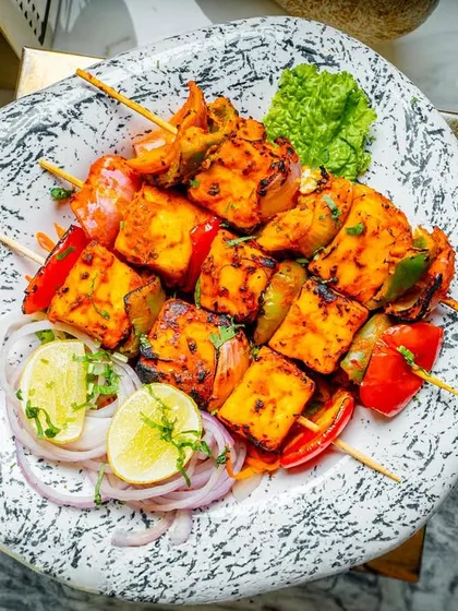 My paneer tikka is a vegetarian favorite. I marinate soft cubes of paneer in a blend of yogurt and spices and grill them to perfection for a smoky, flavorful appetizer.