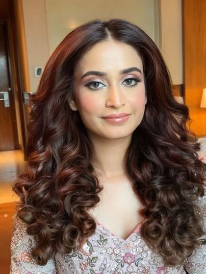 Curls just want to have fun. We used extensions to create these extra-long, voluminous curls for a client who wanted a super glamorous look for her party.