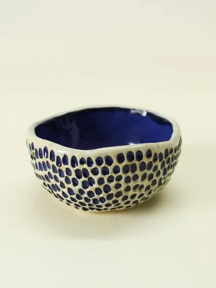 This small Aqua Snack Bowl is perfect for serving nuts, olives, or dips. The vibrant blue interior adds a surprising pop of color to your table setting.