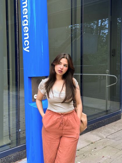 A confident, direct-to-camera pose in the same casual outfit.