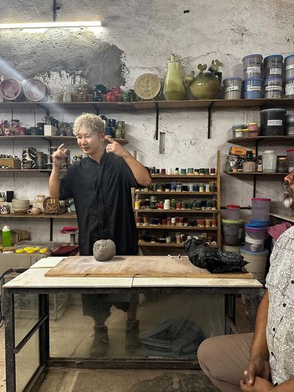 Kazuya Ishida explains his process before starting his demonstration. These interactions are crucial for understanding the philosophy and thought process behind an artist's work.