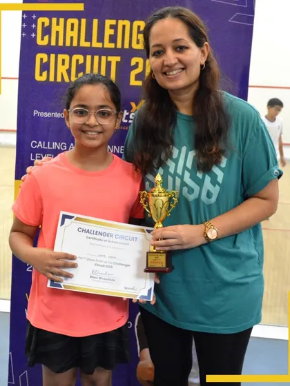 A proud winner of the Challenger Circuit 2025 holds her trophy and certificate, a testament to her hard work and performance.