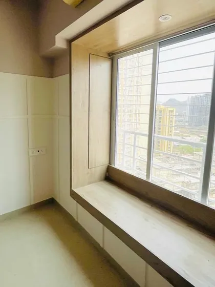 A window can be more than just a source of light. Here, we built a custom wooden frame around the window, creating a deep sill that serves as a display ledge or a cozy seating spot to enjoy the view.
