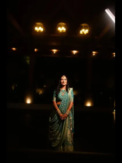 A dramatic, low-light portrait of the bride, using the ambient lighting to create a moody and elegant atmosphere.