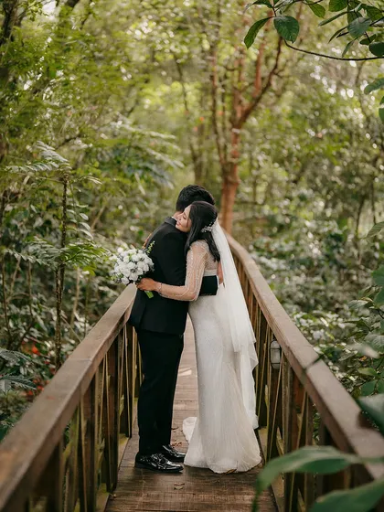 An embrace in the heart of the forest. Jibin and Athira’s post-wedding shoot on this secluded wooden bridge feels like a world away. It’s a quiet, soulful moment that speaks to the peace and sanctuary found in each other's arms.