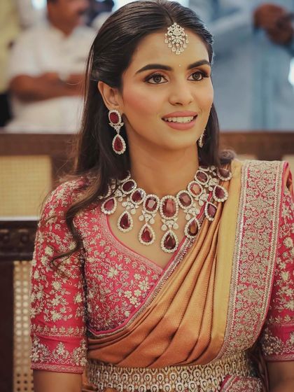 For a traditional Pelikuthuru ceremony, we styled this beautiful Jayanti Reddy saree. The brief was to incorporate a belt, and we paired it with a stunning diamond and ruby necklace to complement the saree's bright colors.