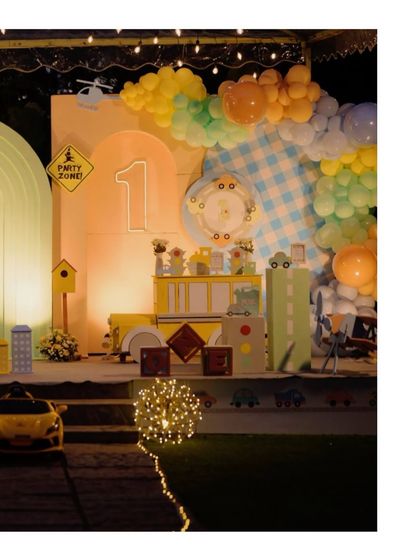 A closer view of the illuminated vehicle party stage, highlighting the 'Party Zone' sign, the light-up '1', and the checkered backdrop.